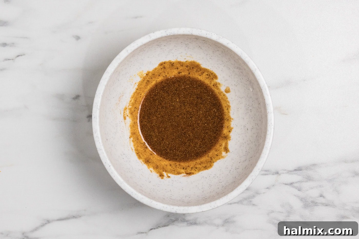 bowl with seasonings and olive oil mixed into a paste