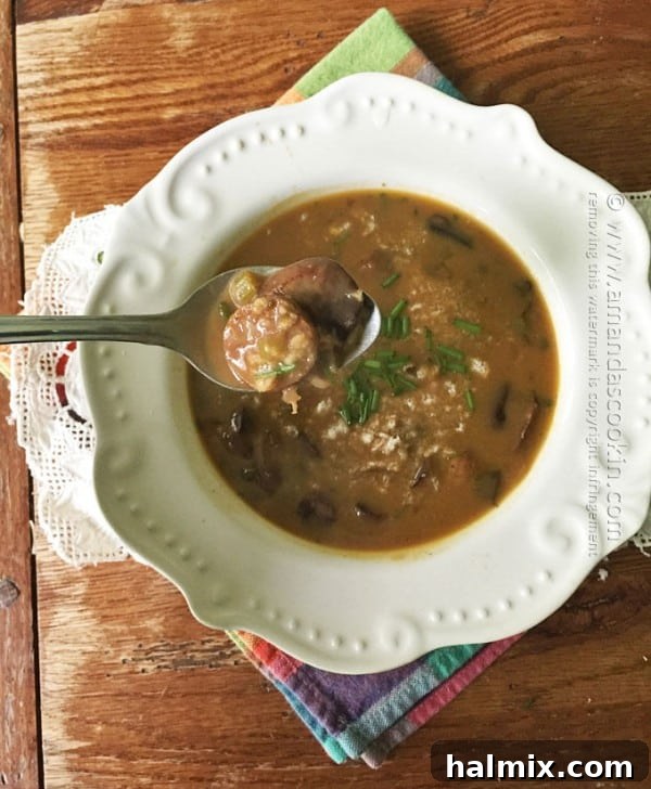 A large pot of simmering Sausage Mushroom & Wild Rice Soup, showing its inviting texture.