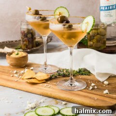 Two Dirty Greek Martinis on a wooden platter