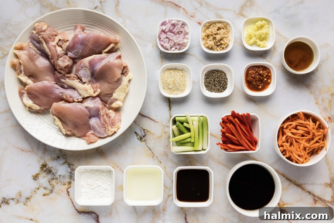 A vibrant display of fresh ingredients for Szechuan Chicken, including colorful vegetables like red bell peppers and carrots, aromatic garlic and ginger, and sauces, all ready for preparation.