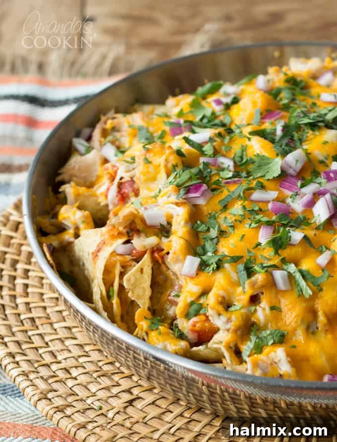 Delicious, fast, easy. A platter of rotisserie chicken nachos promises a delightful and effortless meal or snack.