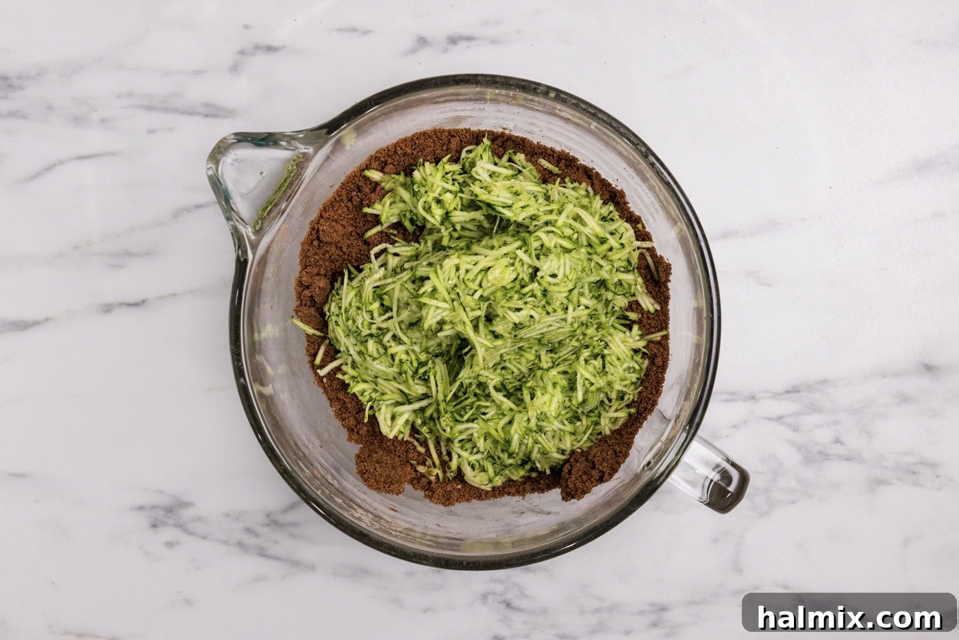 Hidden Veggie Fudge Brownies 8 shredded zucchini added to bowl with brownie mixture