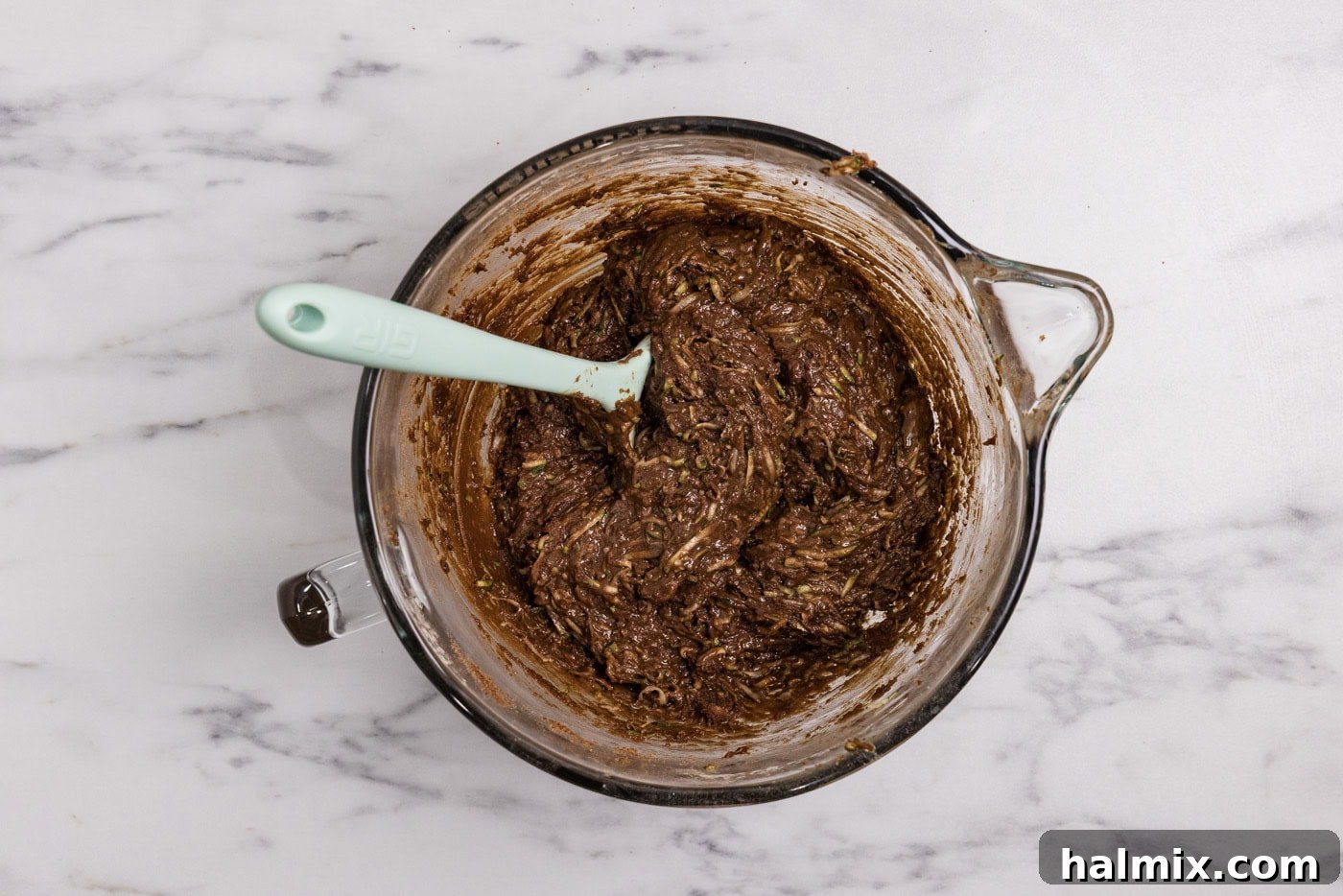 Hidden Veggie Fudge Brownies 9 Rubber spatula in a bowl with zucchini brownie batter