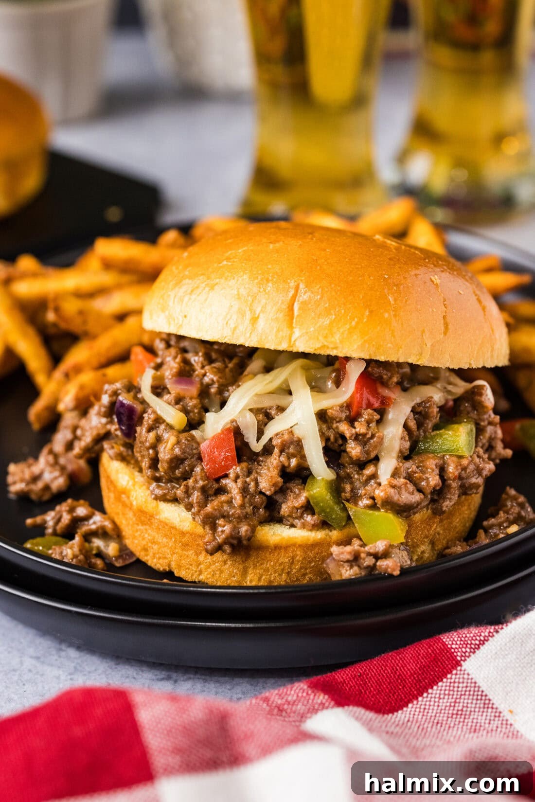 Philly Cheesesteak Sloppy Joe on a plate with french fries