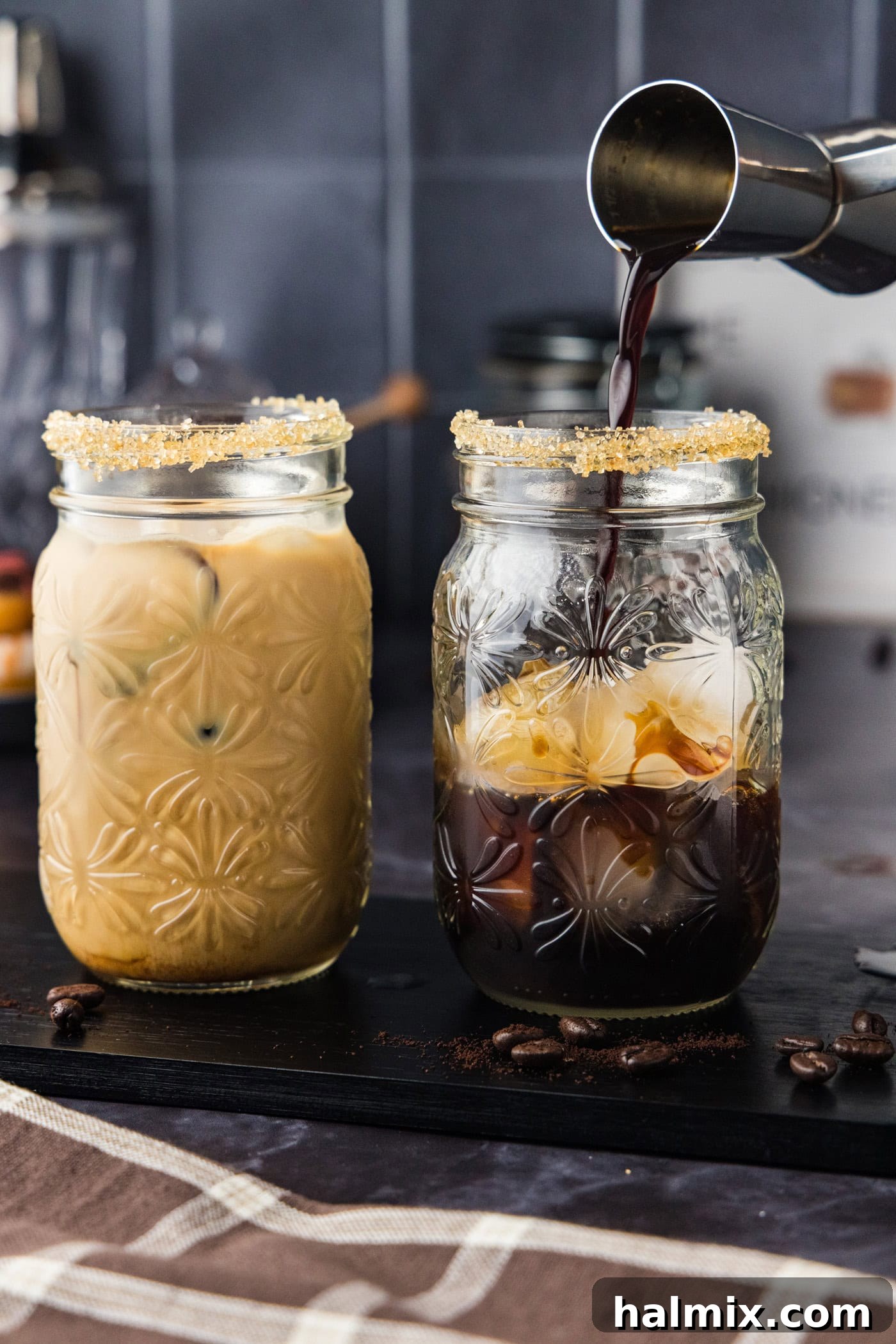 jigger pouring espresso into glass with vodka