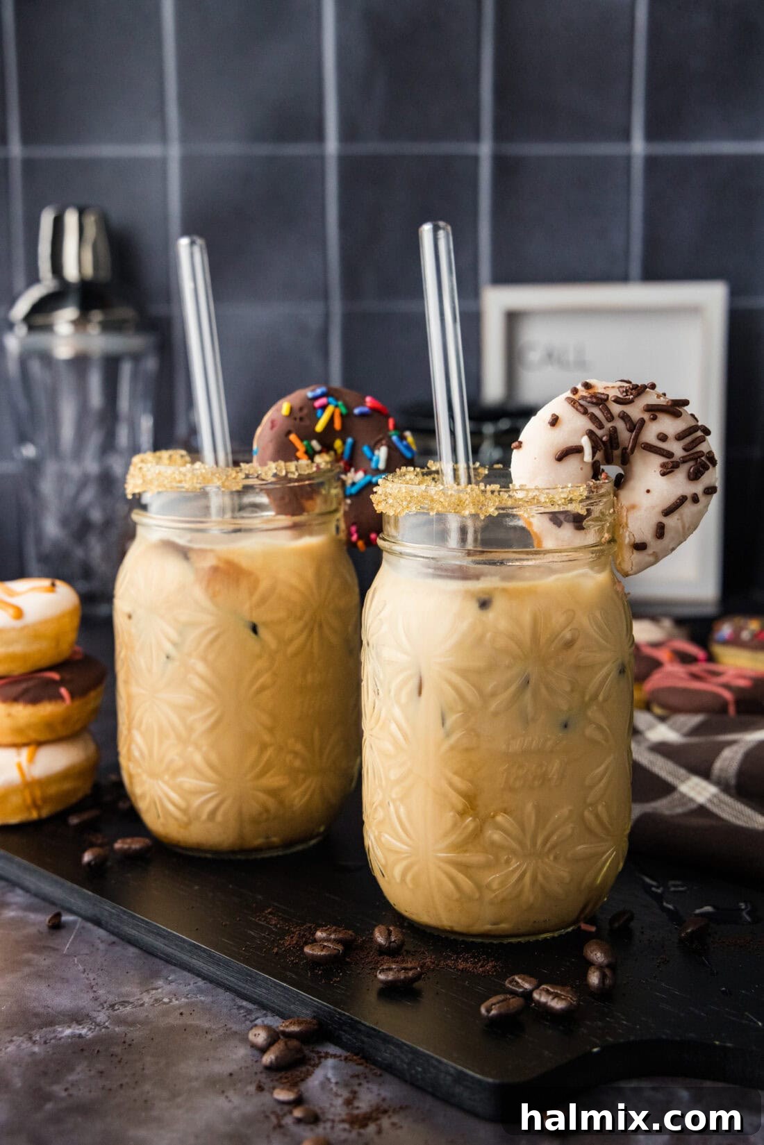 Two Iced Espresso Cocktails garnished with mini donuts