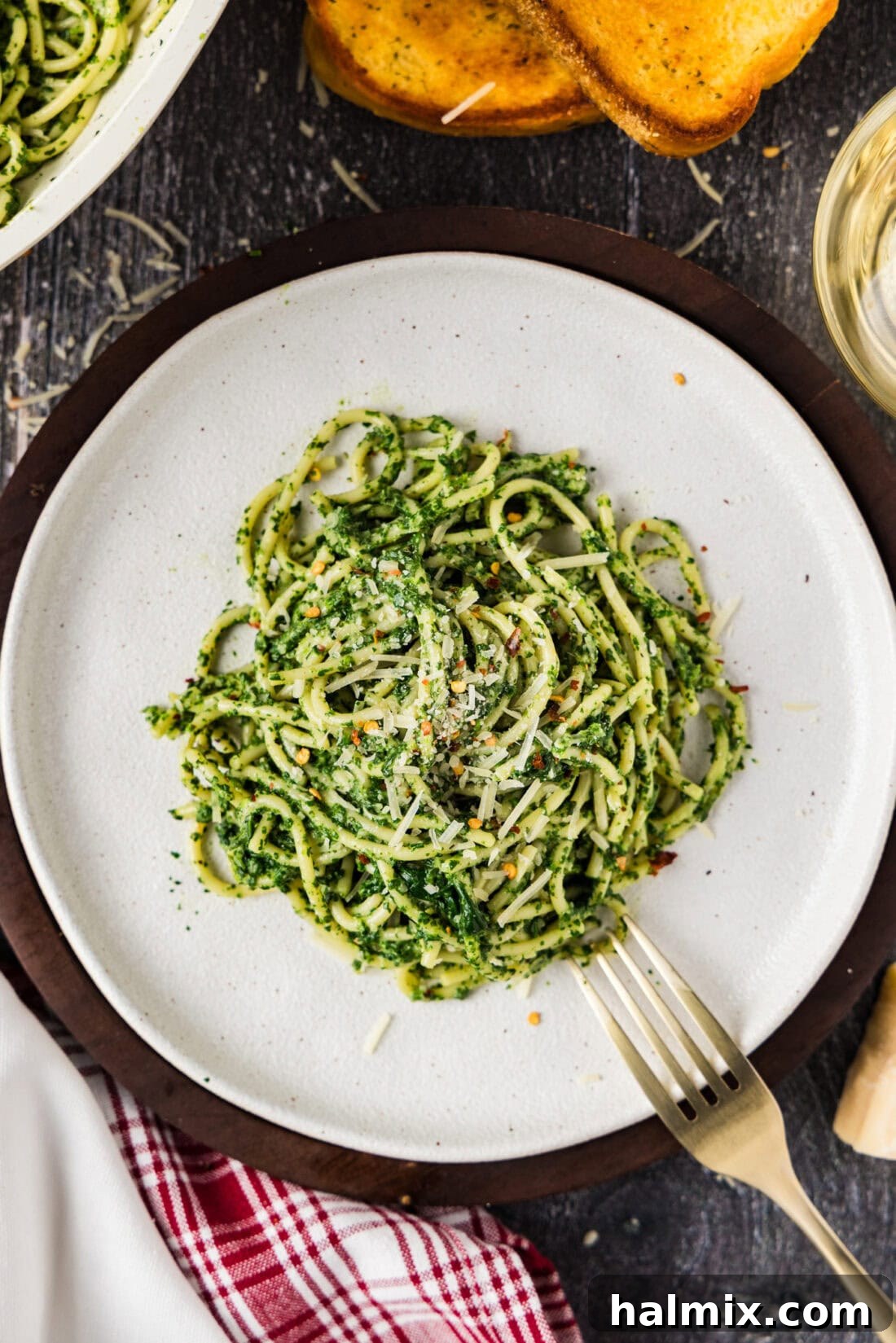 Plate of Spinach Spaghetti with a fork resting on the side, ready to eat