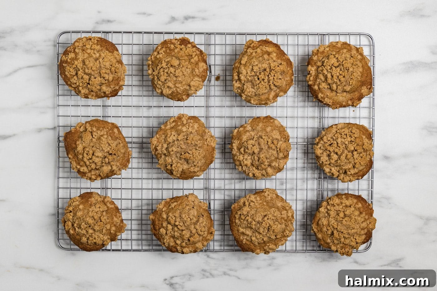 baked apple streusel muffins on a wire cooling rack
