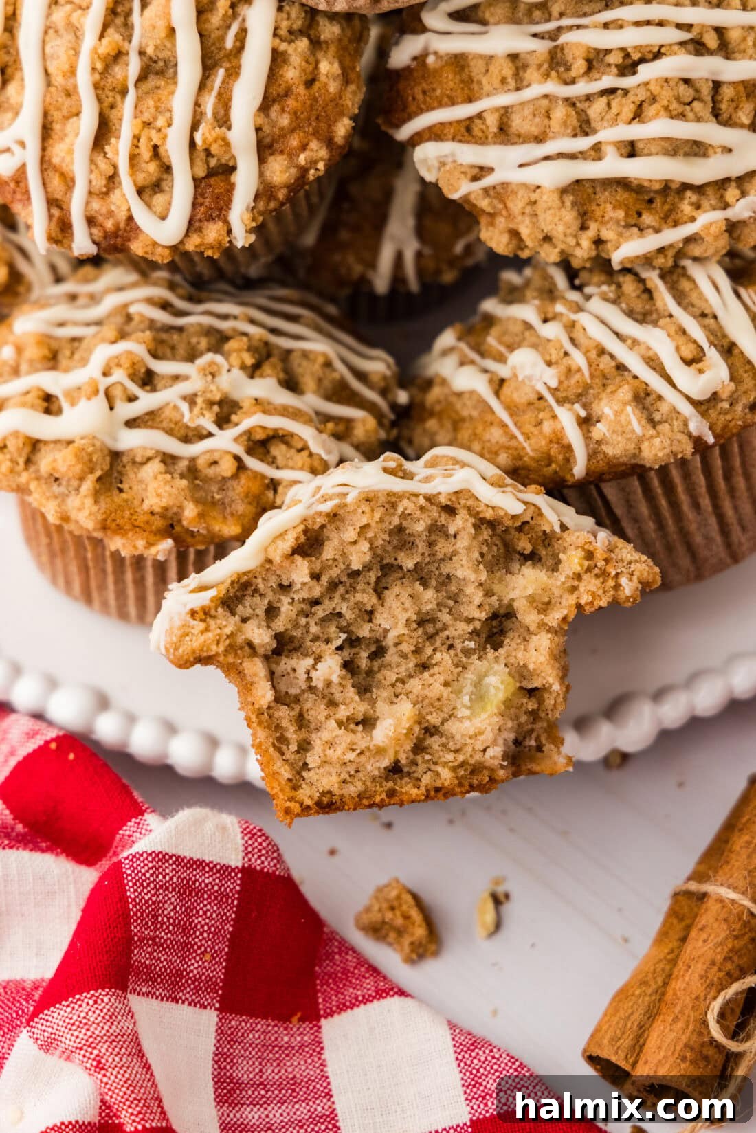 Close up photo of half of a Apple Muffin with more muffins behind it