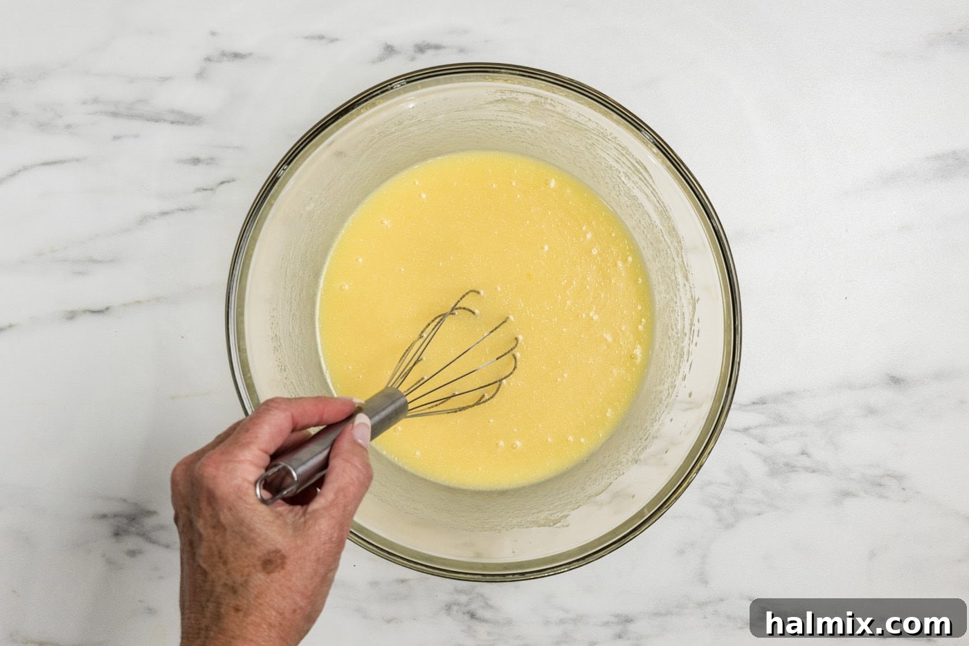 whisking wet ingredients for apple muffins in a bowl