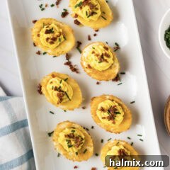 Close up photo of Fried Deviled Eggs on a white platter