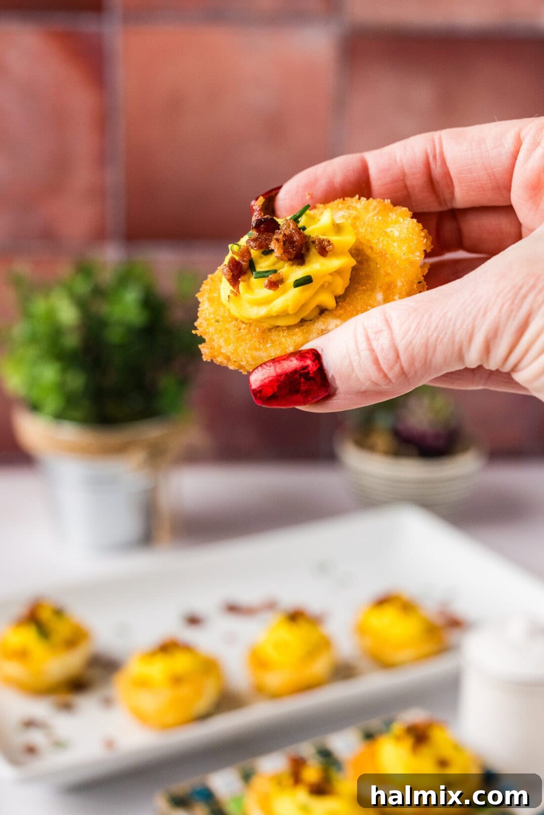 Hand holding up a Fried Deviled Egg