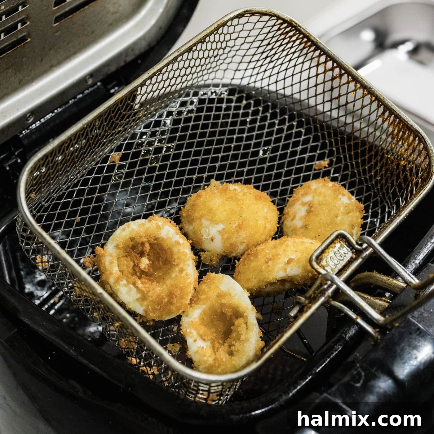 deep fried deviled eggs in a fryer basket