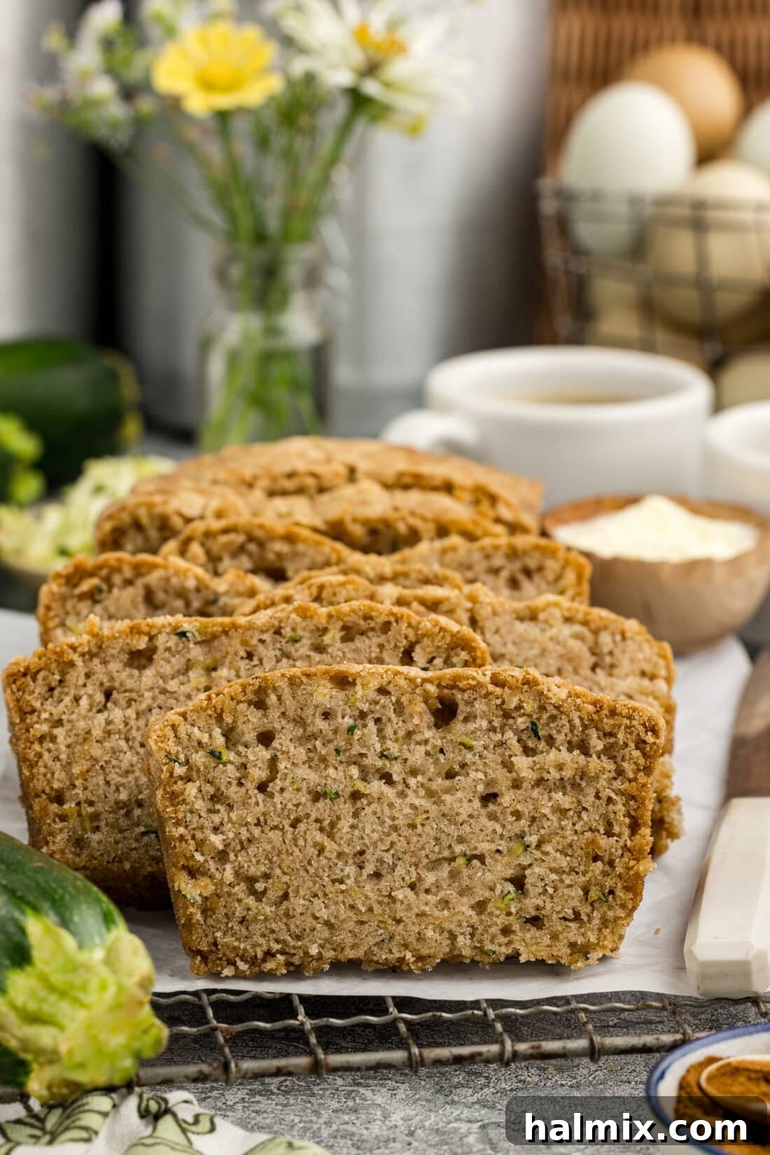 Squash Loaf 3 Slices of Zucchini Bread resting on a parchment-lined wire rack, cooling.