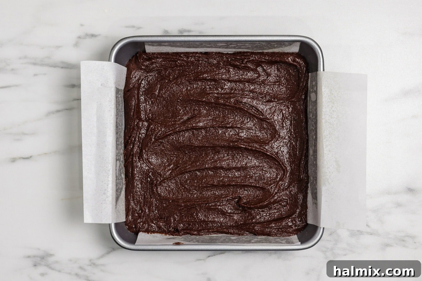 Spiced Pumpkin Swirl Brownies 11 brownie batter spread in a 9x9 baking pan