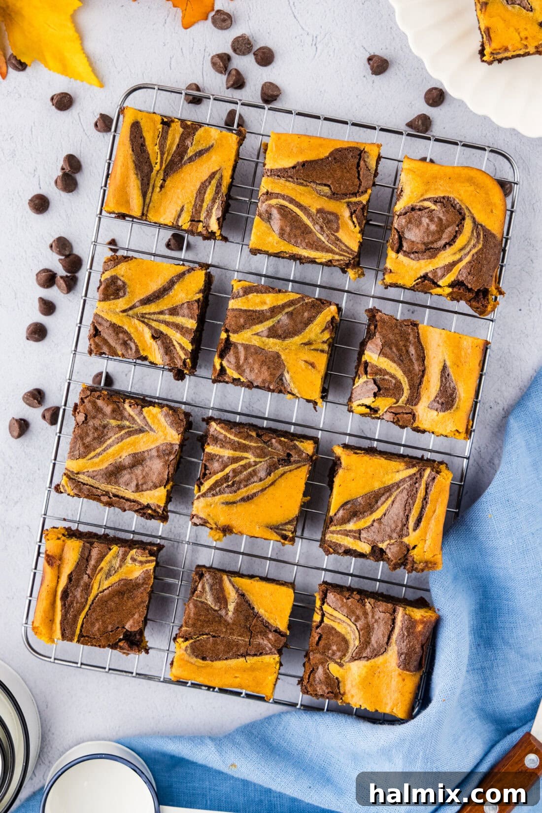 Spiced Pumpkin Swirl Brownies 3 Pumpkin Cheesecake Brownies on a wire rack