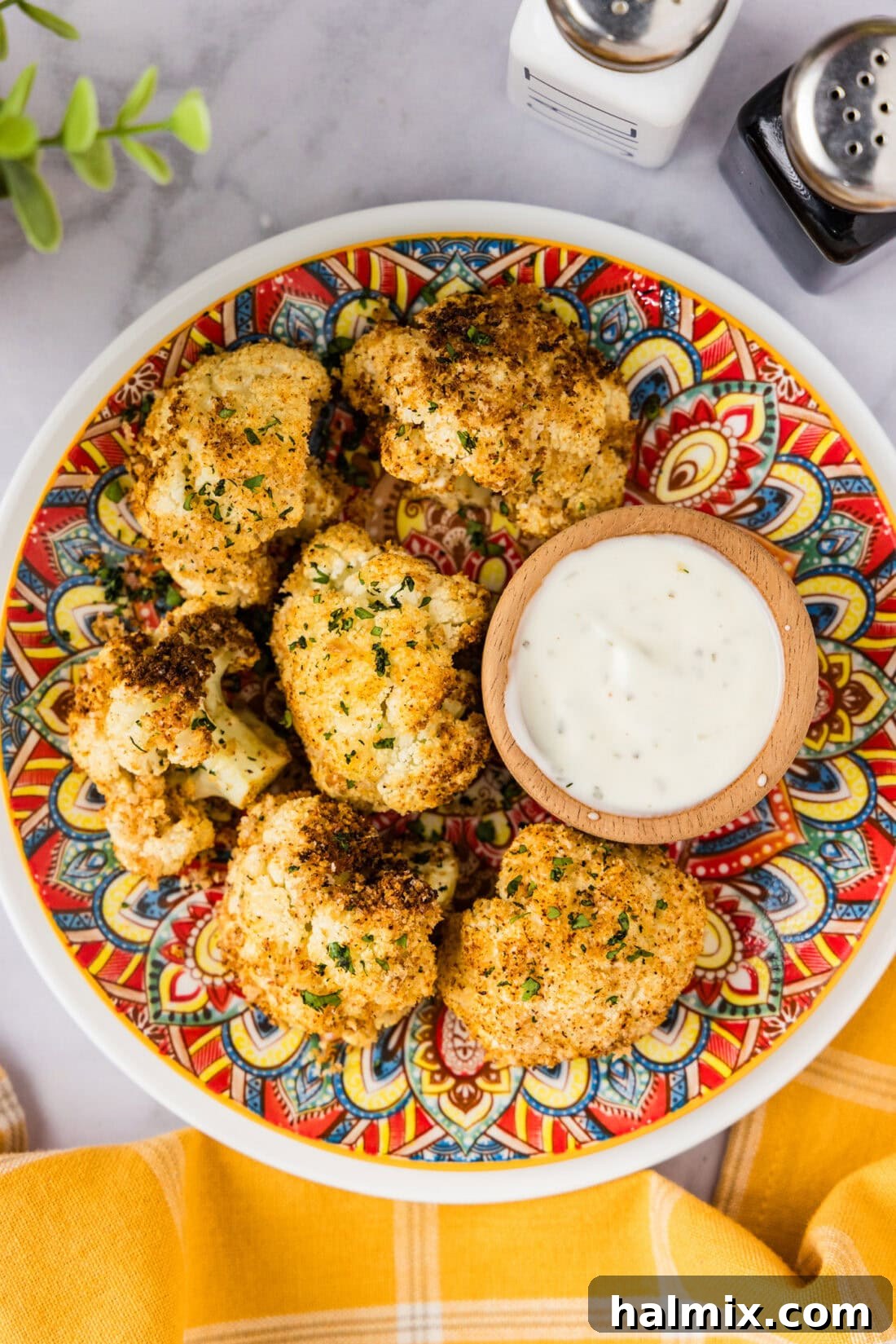 Perfectly Crispy Air Fryer Cauliflower 2 Crispy golden Air Fryer Fried Cauliflower on a plate with ranch dressing, ready to be enjoyed.