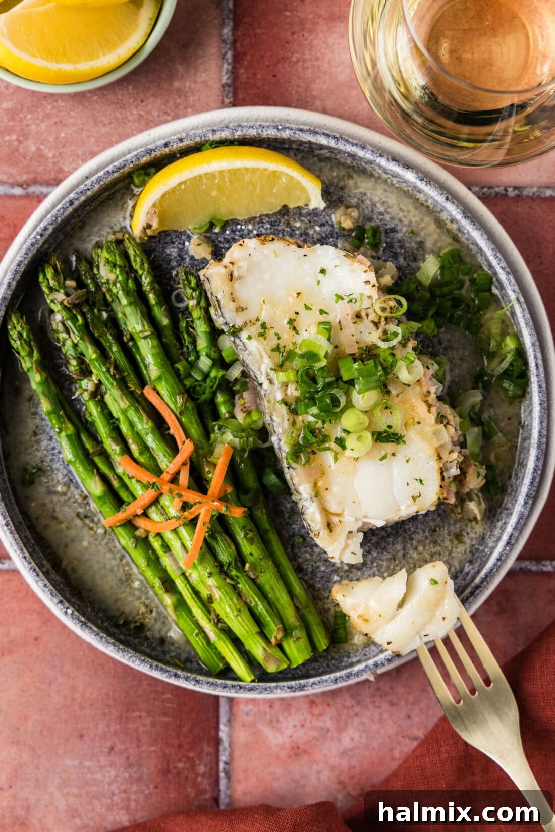 Perfectly Steamed Chilean Sea Bass on a plate, flaked gently with a fork