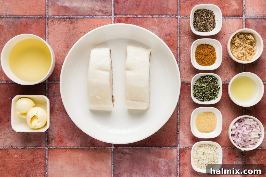 Arrangement of fresh ingredients for Steamed Chilean Sea Bass, including fish fillets, butter, shallots, lemon, and spices