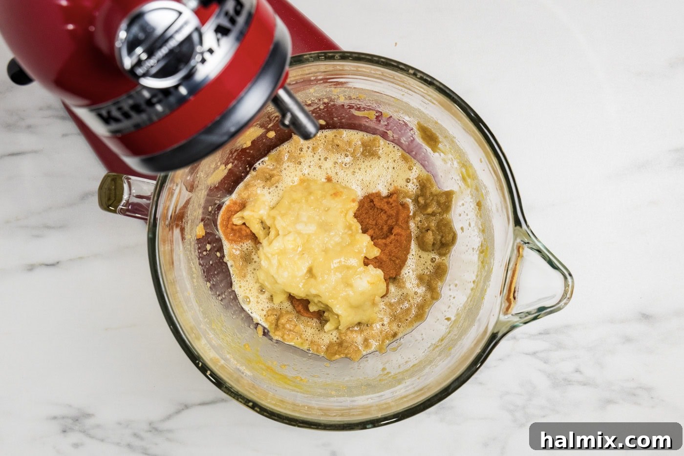 spices, pumpkin, and banana added to mixture in stand mixer bowl