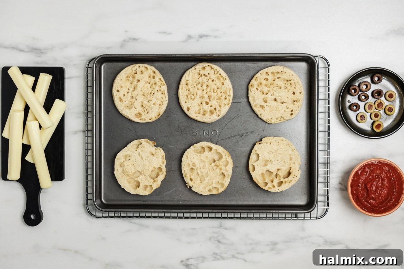 toasted English muffins on a baking sheet