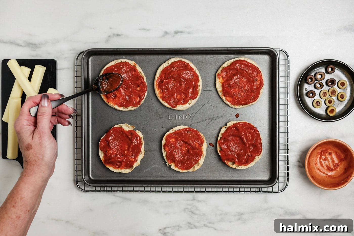 basting English muffins with pizza sauce