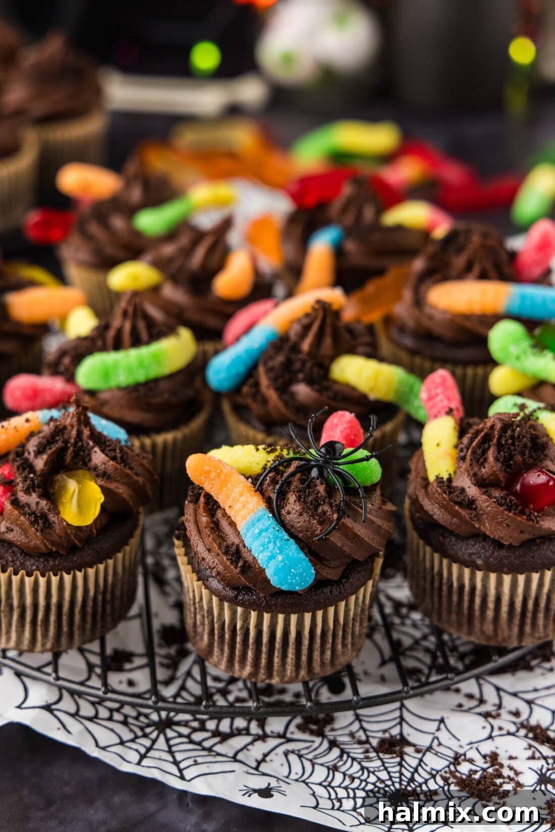 Halloween Dirt Cupcakes on a wire rack ready for a spooky celebration