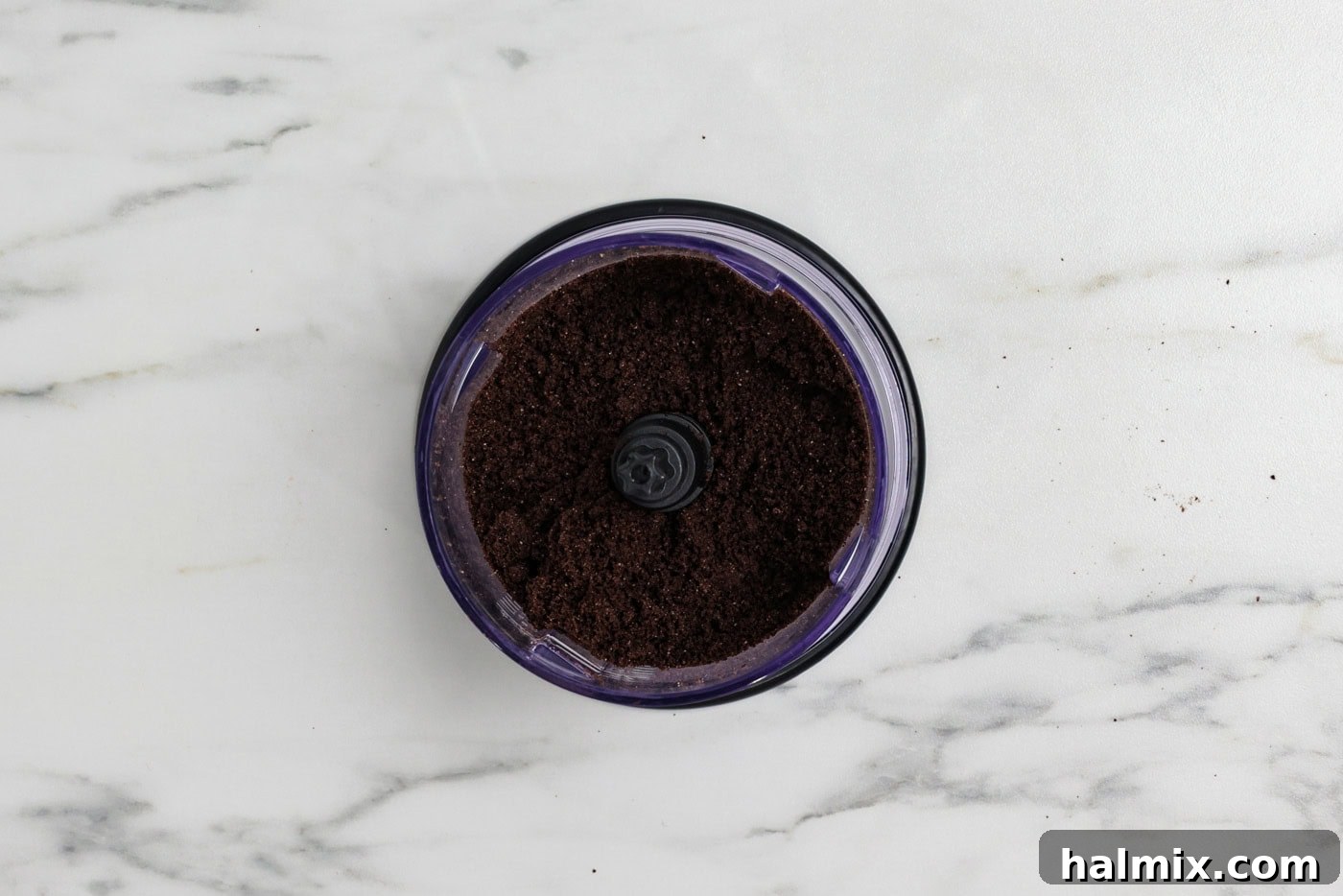 Oreo cookies being blitzed in a food processor to create crumbs