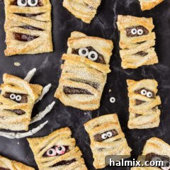 Mummy Hand Pies with one resting in a skeleton hand, a spooky Halloween treat