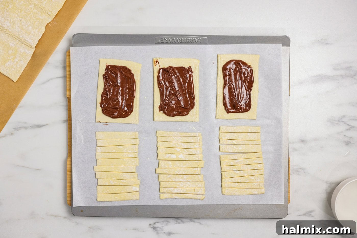 Nutella spread evenly in the center of puff pastry rectangles, leaving a clean border