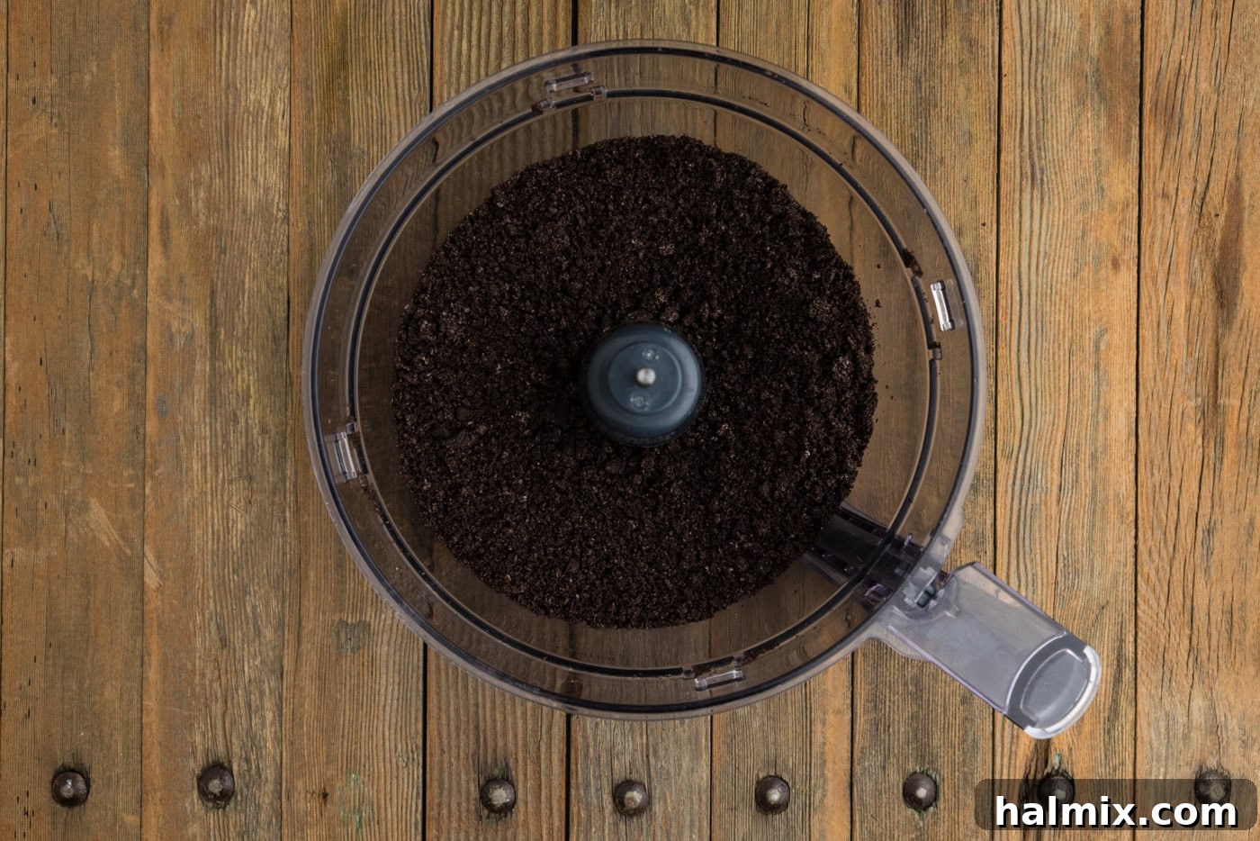 Finely crushed Oreo cookies in the bowl of a food processor, ready to be mixed for the truffle base.