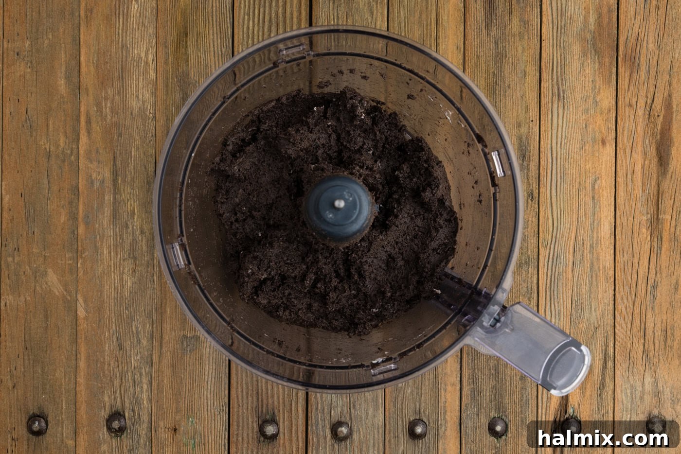 The fully combined Oreo and cream cheese mixture in a food processor, resembling a dark, cohesive dough, ideal for forming truffles.