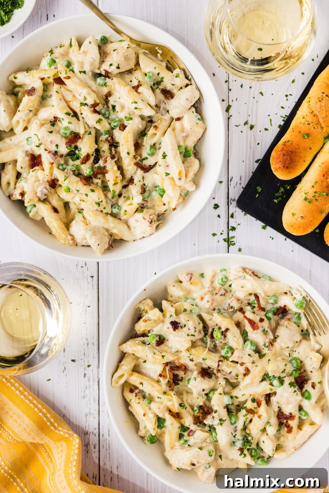 Two neatly plated bowls of Chicken Carbonara, garnished and ready to be enjoyed.