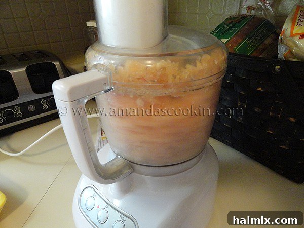Close-up photo of raw boneless, skinless chicken breasts cut into uniform cubes, ready for the food processor.