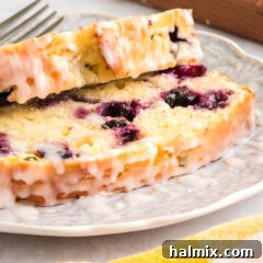 sliced lemon blueberry zucchini bread with glaze