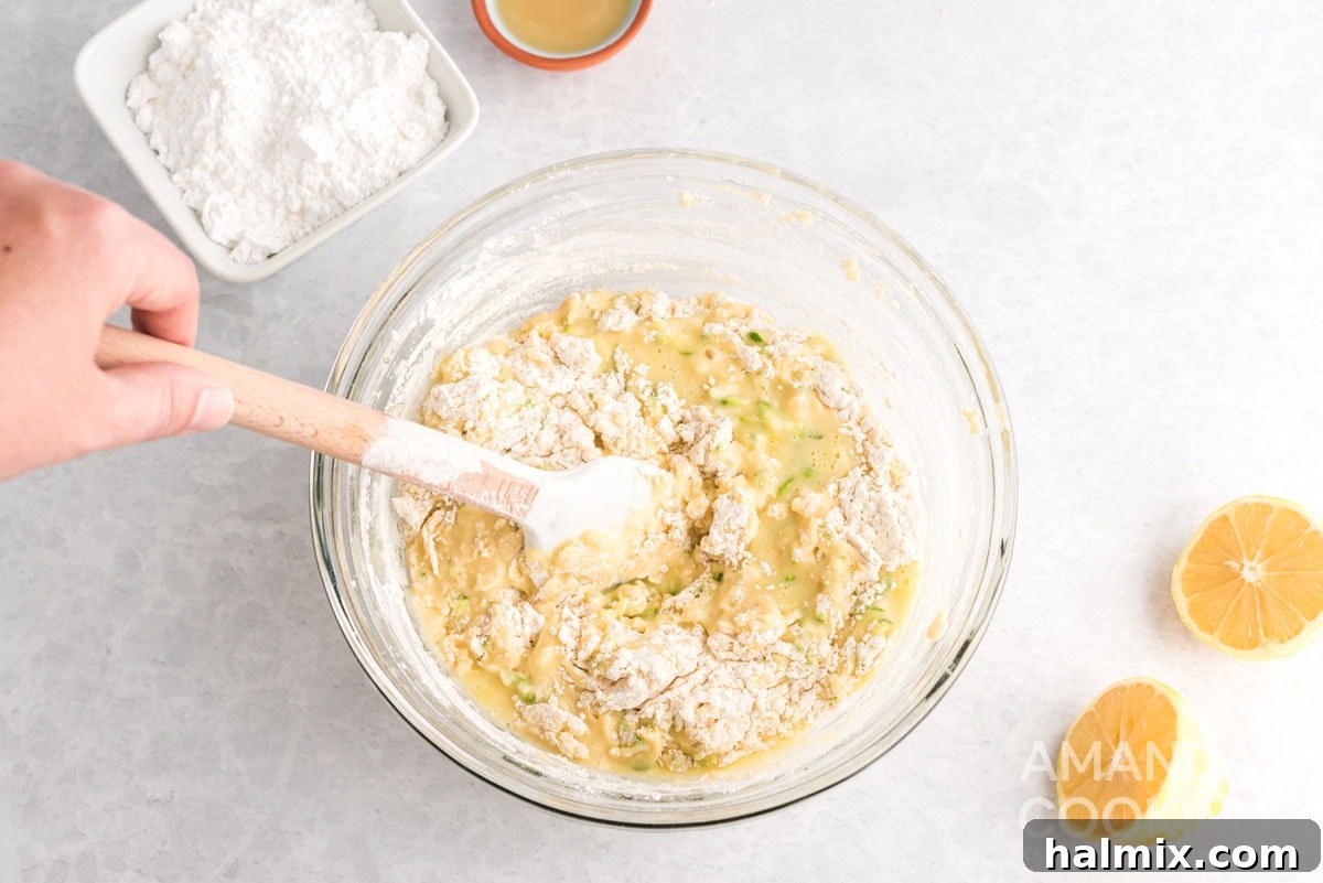 gently stirring dry ingredients into the zucchini bread batter until just combined