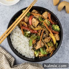 Bowl of Tofu Stir Fry with chopsticks on the side, a complete and appealing meal.