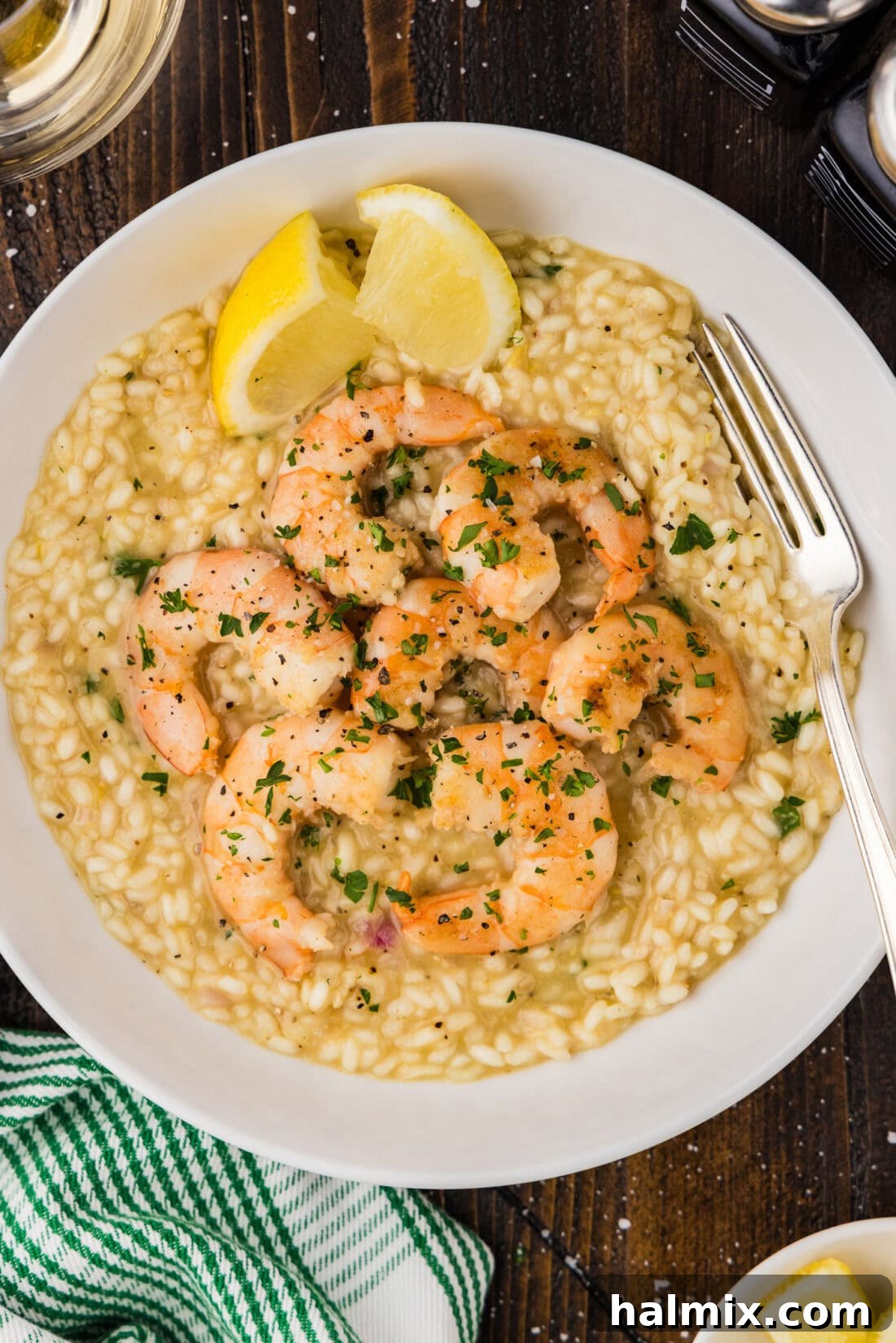 Creamy Prawn Risotto 2 Bowl of Creamy Shrimp Risotto with a fork in it, garnished with fresh herbs.