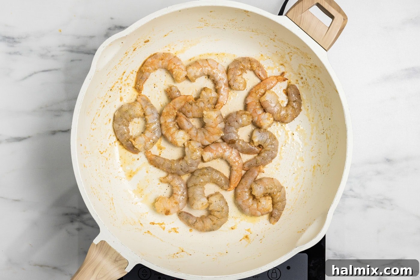 Creamy Prawn Risotto 5 Partially cooked seasoned shrimp in a skillet, just turning pink.