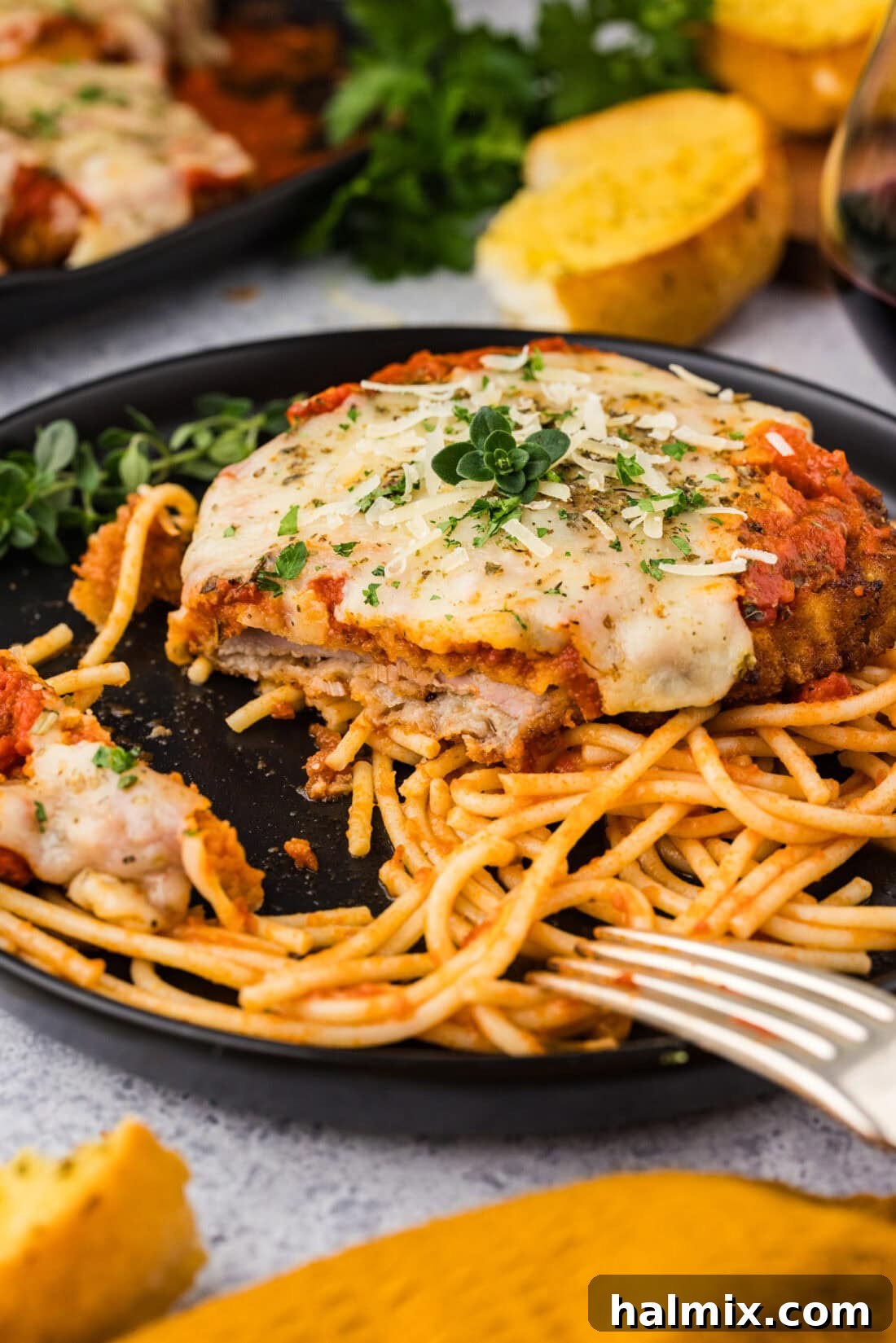 Plate of Veal Parmesan on spaghetti with a bite removed