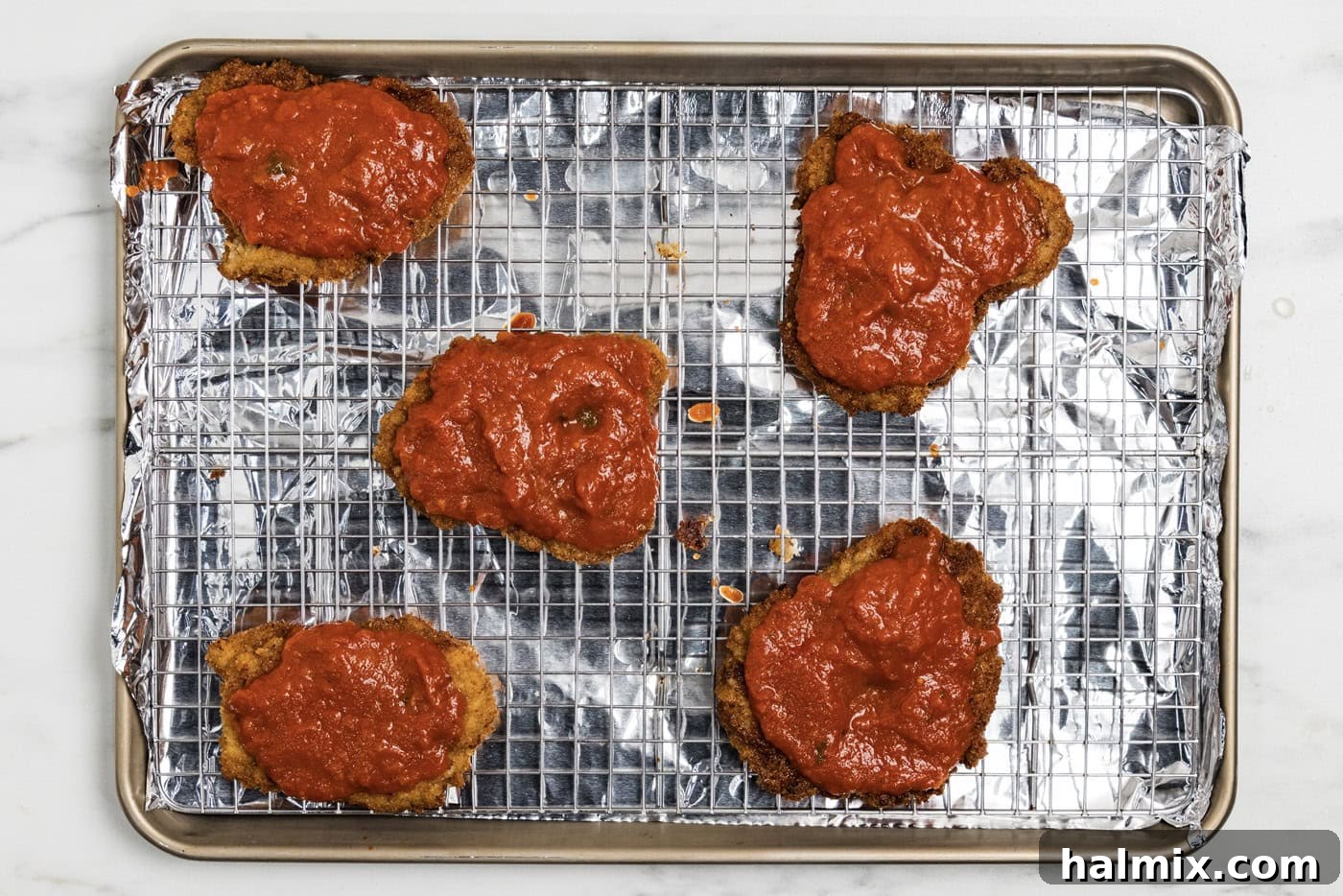 marinara sauce over cooked breaded veal cutlets