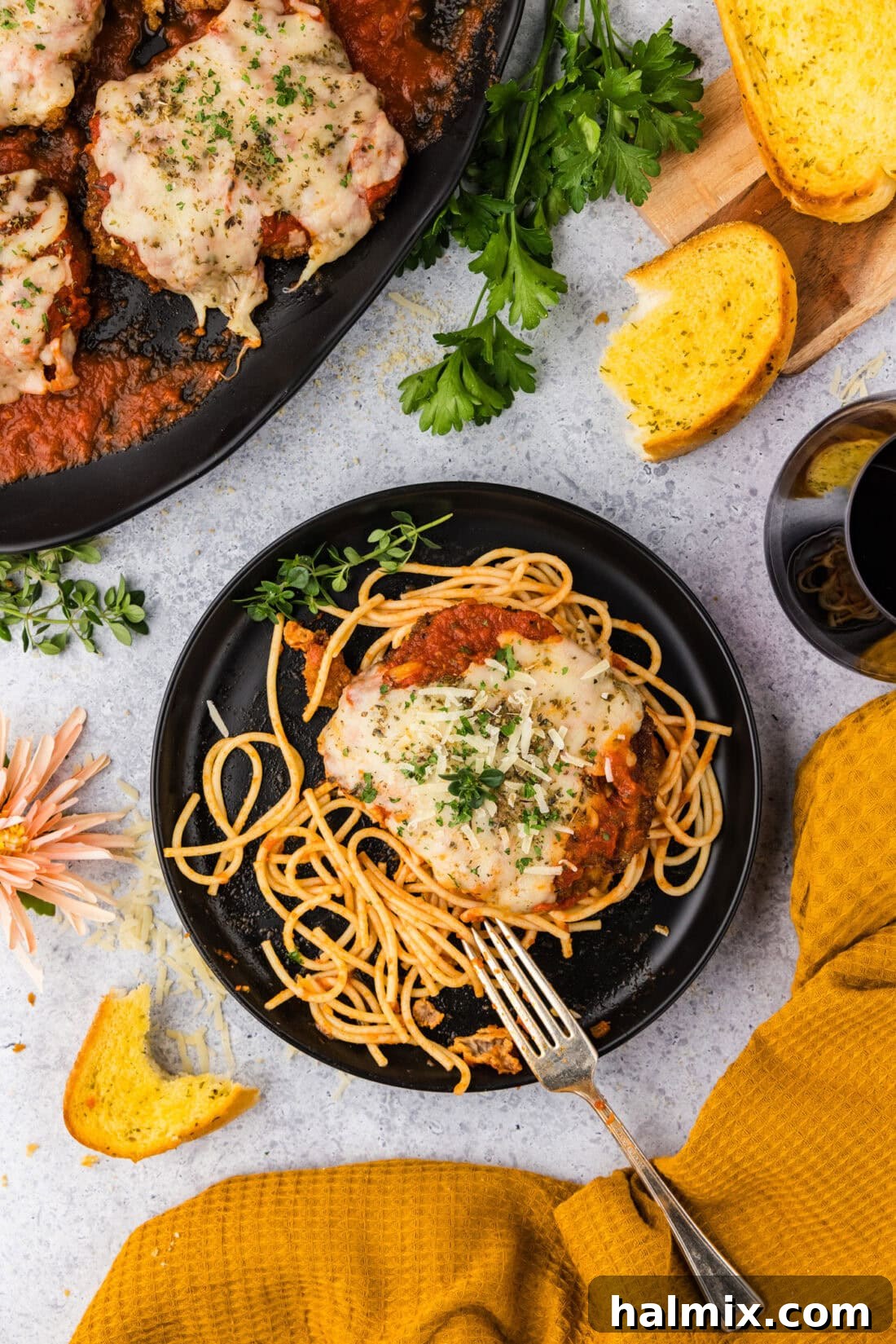 Plate of Veal Parmesan with garlic bread to the side