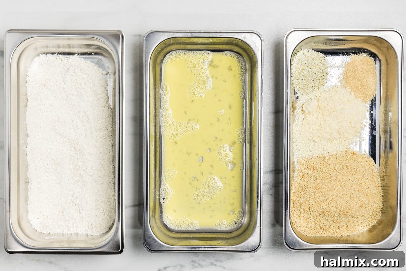 breading trays with flour in one, egg in the next, and panko bread crumb mixture in the third.