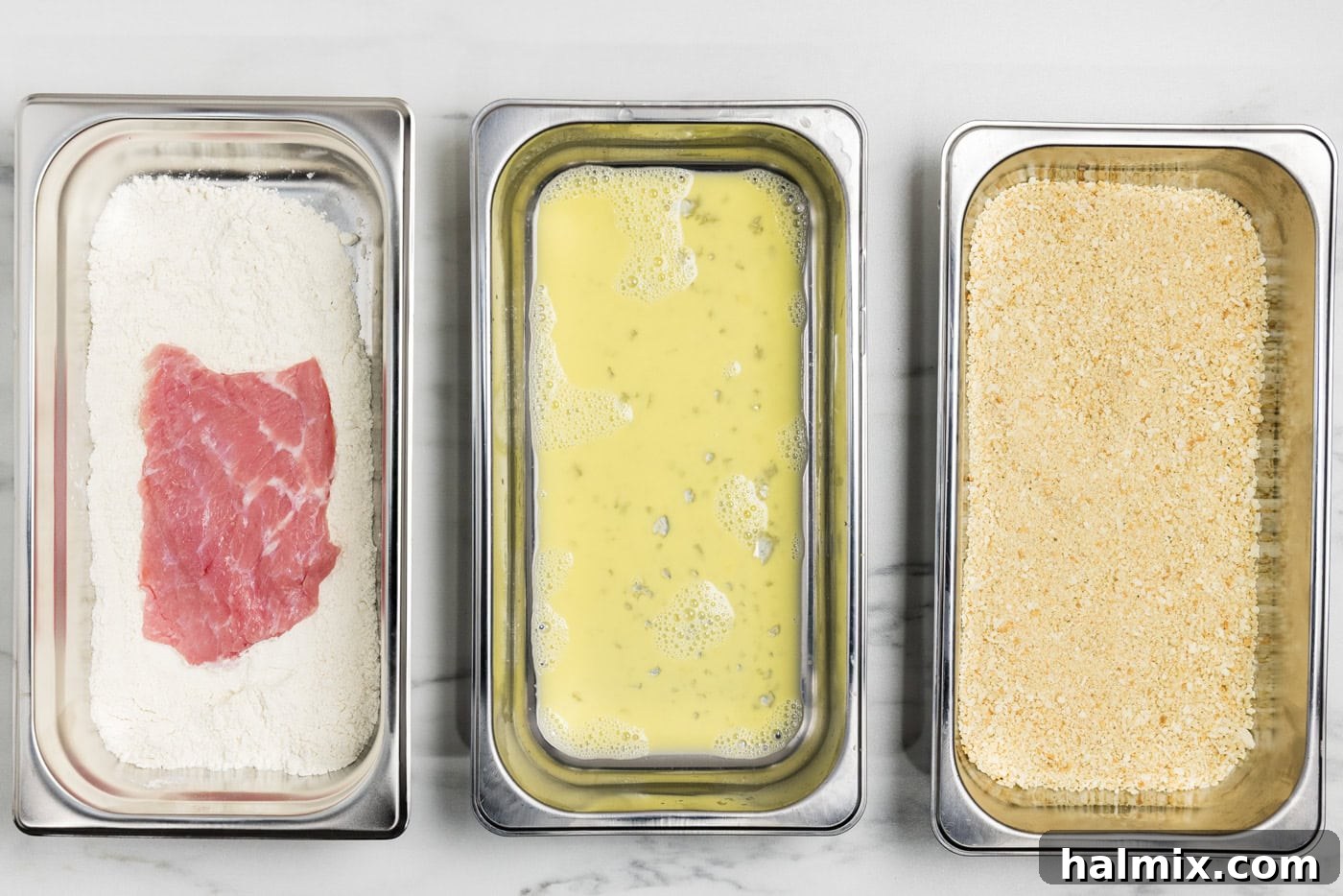 Veal cutlets in a breading pan of flour