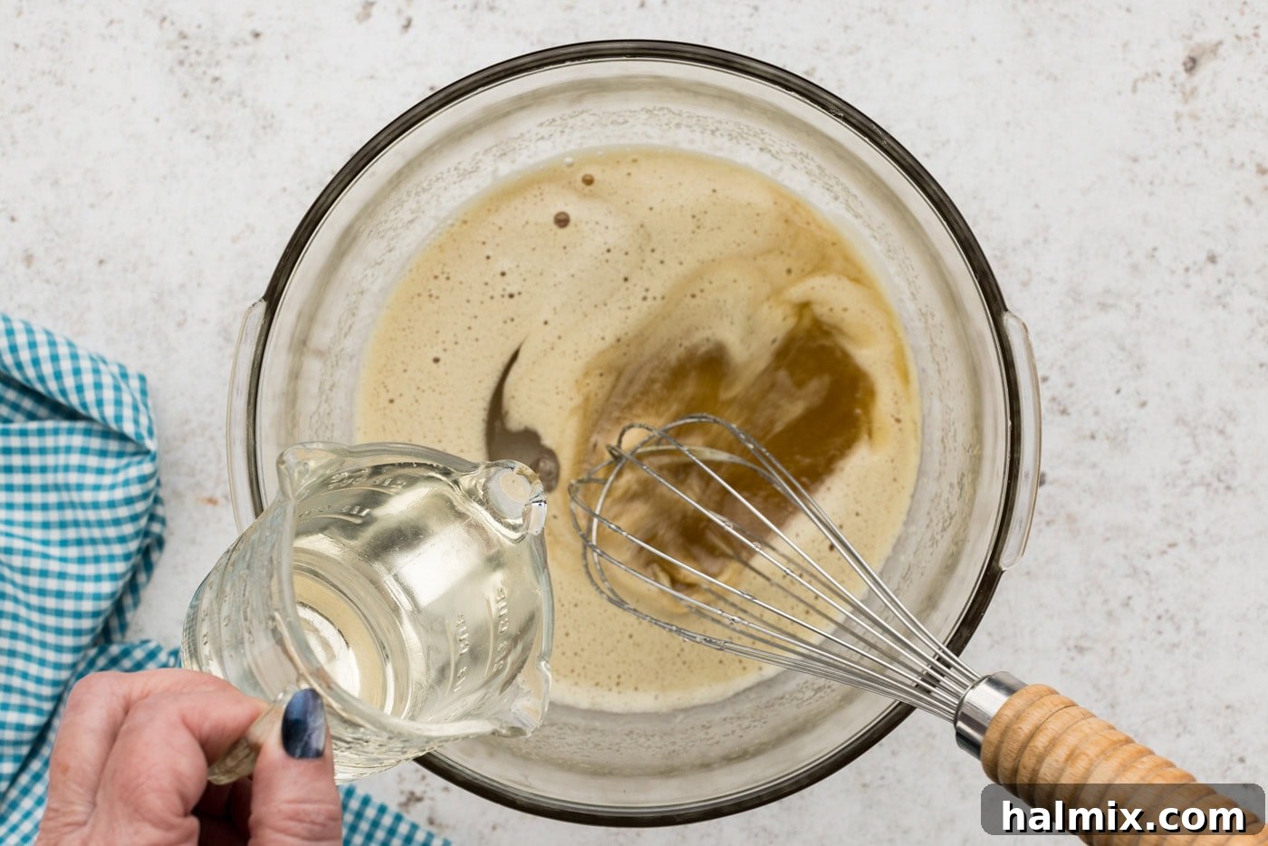 Decadent Pecan Pie Squares 7 Pouring corn syrup into a sugar and egg mixture, beating with a whisk to combine ingredients for the filling.