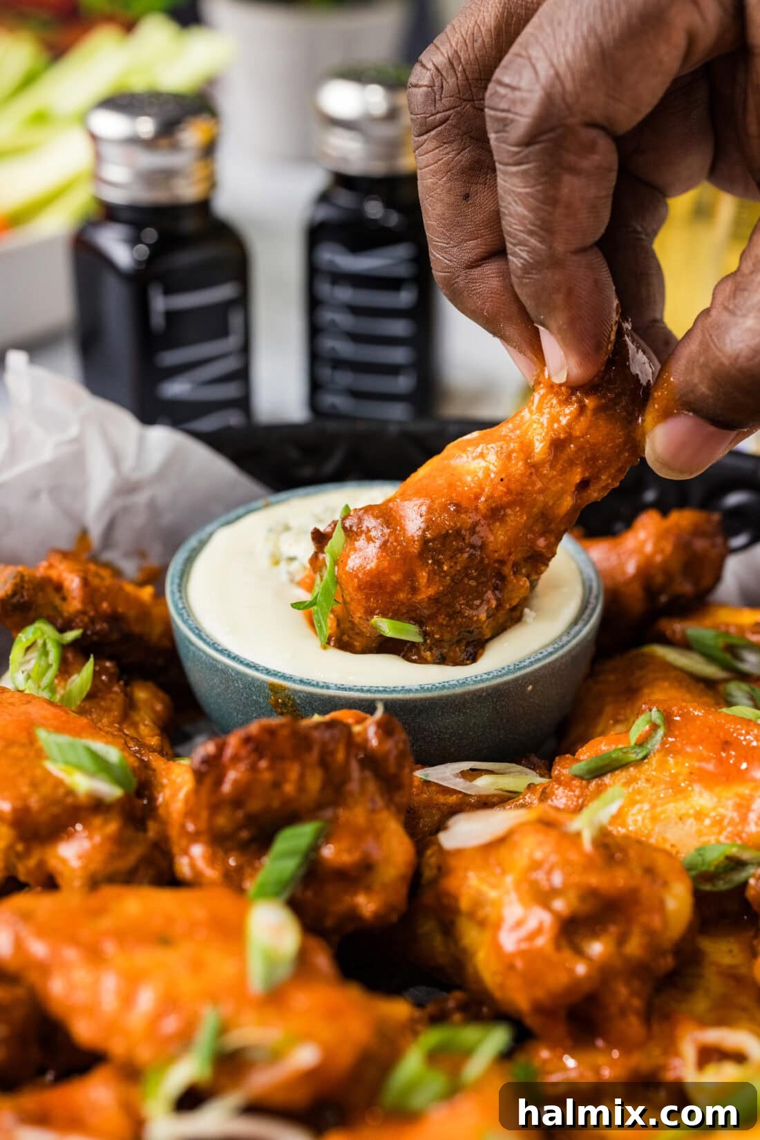 Buffalo Chicken Wing being dipped in blue cheese