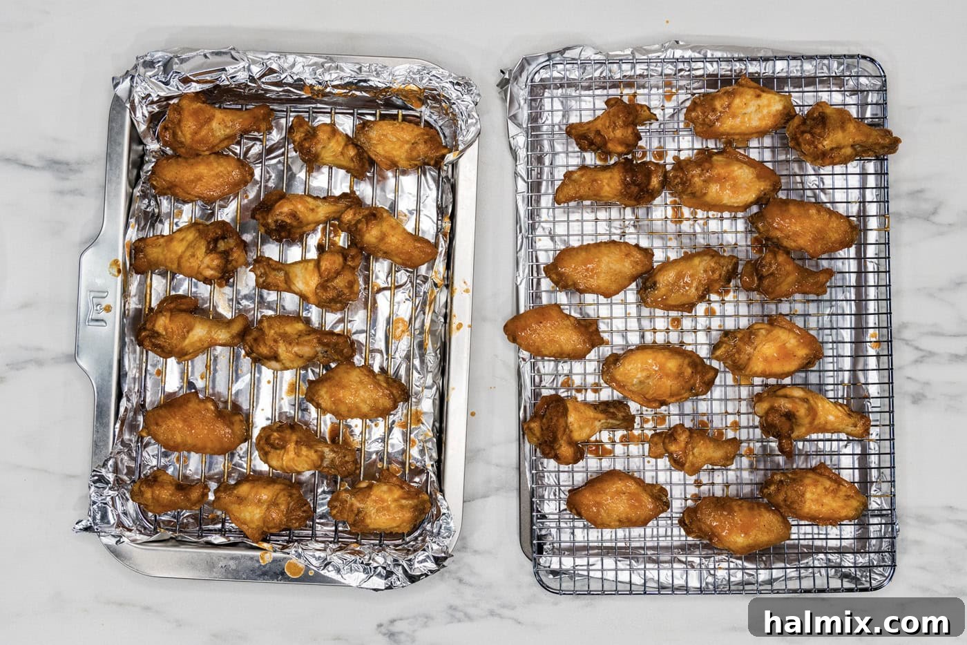 sauced chicken wings on a wire rack over a baking sheet