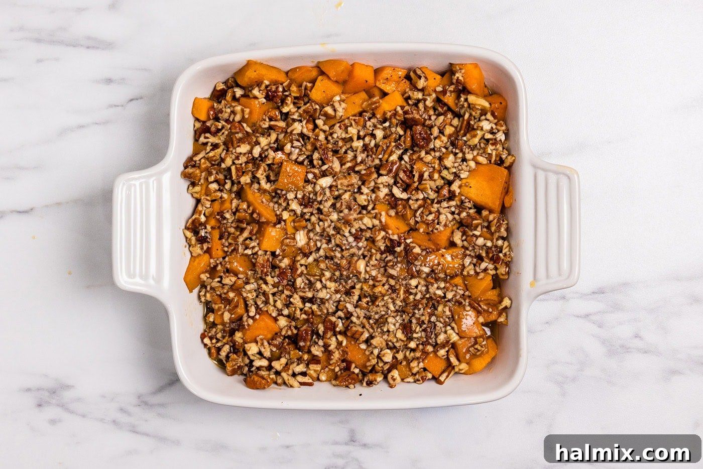 Bourbon Glazed Sweet Potatoes 11 bourbon sweet potatoes in a baking dish topped with chopped pecans