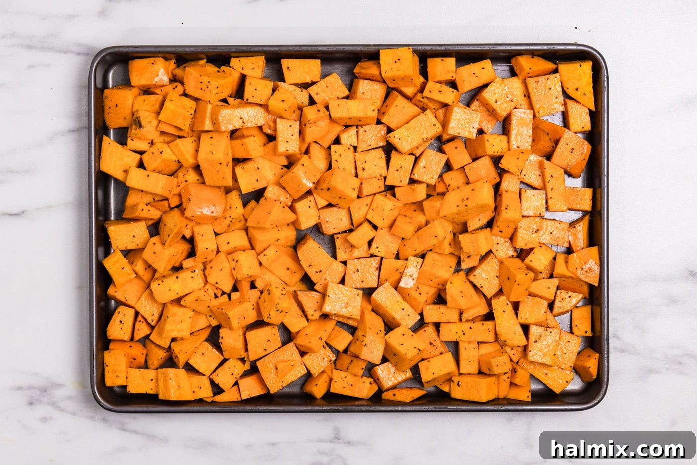 Bourbon Glazed Sweet Potatoes 6 seasoned and oiled cubed sweet potatoes on a baking sheeet