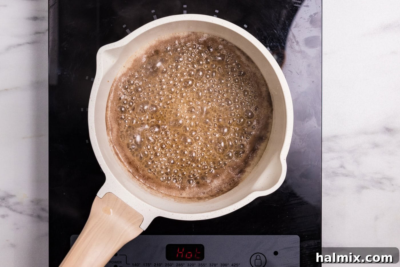 Bourbon Glazed Sweet Potatoes 8 brown sugar, maple syrup, and bourbon sauce in a saucepan bubbling